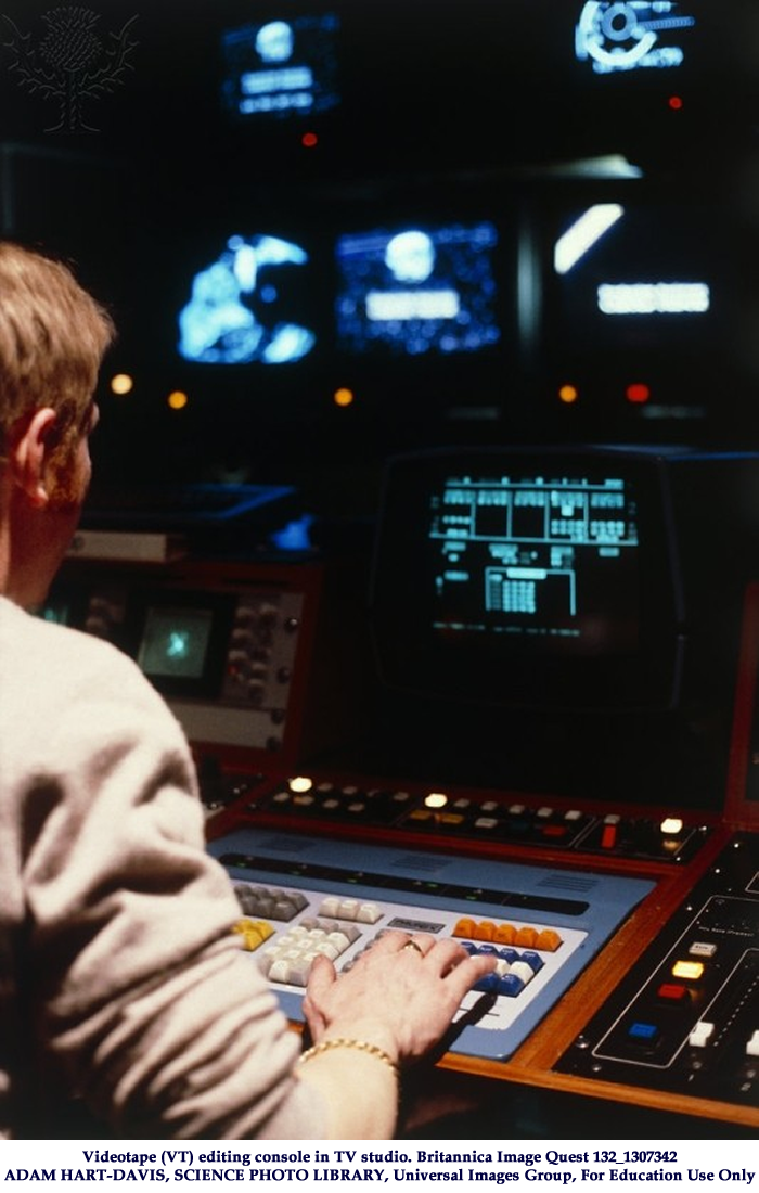 Videotape (VT) editing console in TV studio. The black surface in the foreground (right) is the Sound Mixer & the white sliders on this, known as faders, adjust the sound level. The VT engineer, on the left, is seated at the keyboard of the Editor which operates most of the editing processes. The TV screen immediately above the Editor displays the Time Codes. Further along the console (not visible in this photograph) is the Vision Mixer unit also operated by the VT engineer. At the far end of the console the assistant operates the VT machines & the special effects unit. Videotape (VT) editing console in TV studio. Britannica Image Quest 132_1307342
ADAM HART-DAVIS, SCIENCE PHOTO LIBRARY, Universal Images Group, For Education Use Only